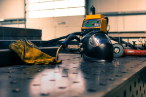 A closeup of equipment for steel cutting in a workshop with a blurry background