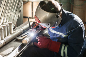 Closeup of man wearing mask welding in a workshop