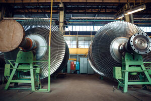 Impellers with vanes on turbine factory, nobody. Power machines manufacturing industry, plant interior on background, industrial machinery