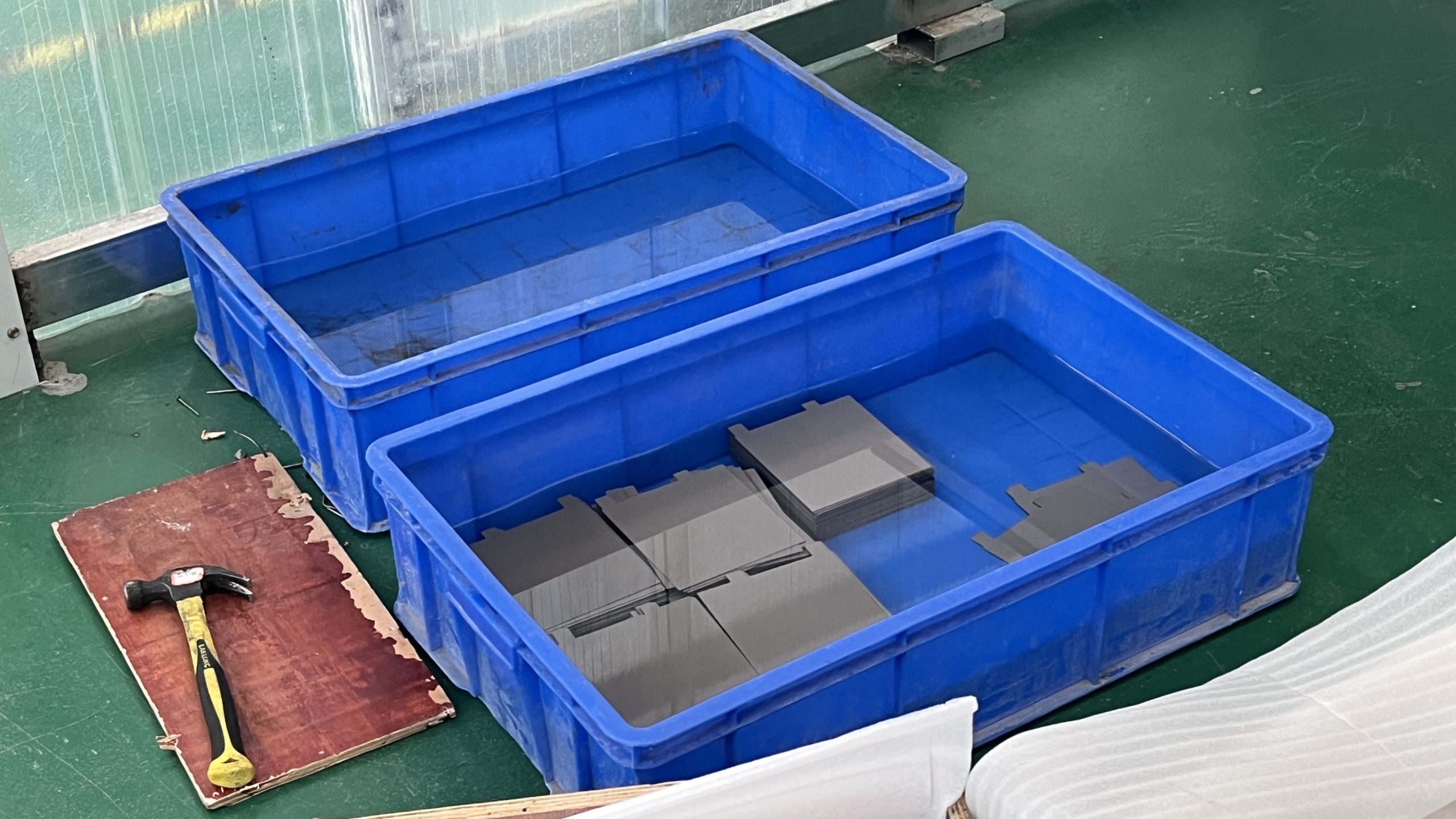 Plate MMO titanium anodes held in water during coating hydration and QC