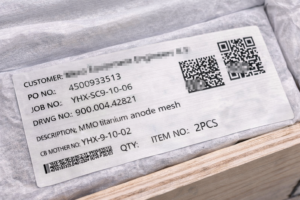 External packaging label for MMO titanium anode mesh, showing PO, job number, drawing reference, batch ID, and QR code for full inspection and traceability records, without contacting the coated surface.