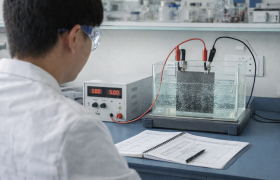 An accelerated lifetime test of titanium anode plates conducted under controlled laboratory conditions, with energized electrodes, gas evolution, and real-time data recording.